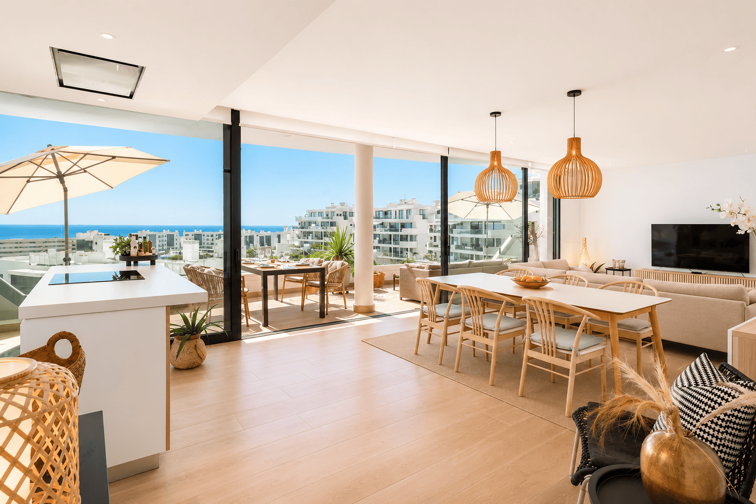 Open-plan living and dining area opening onto the terrace with sea views
