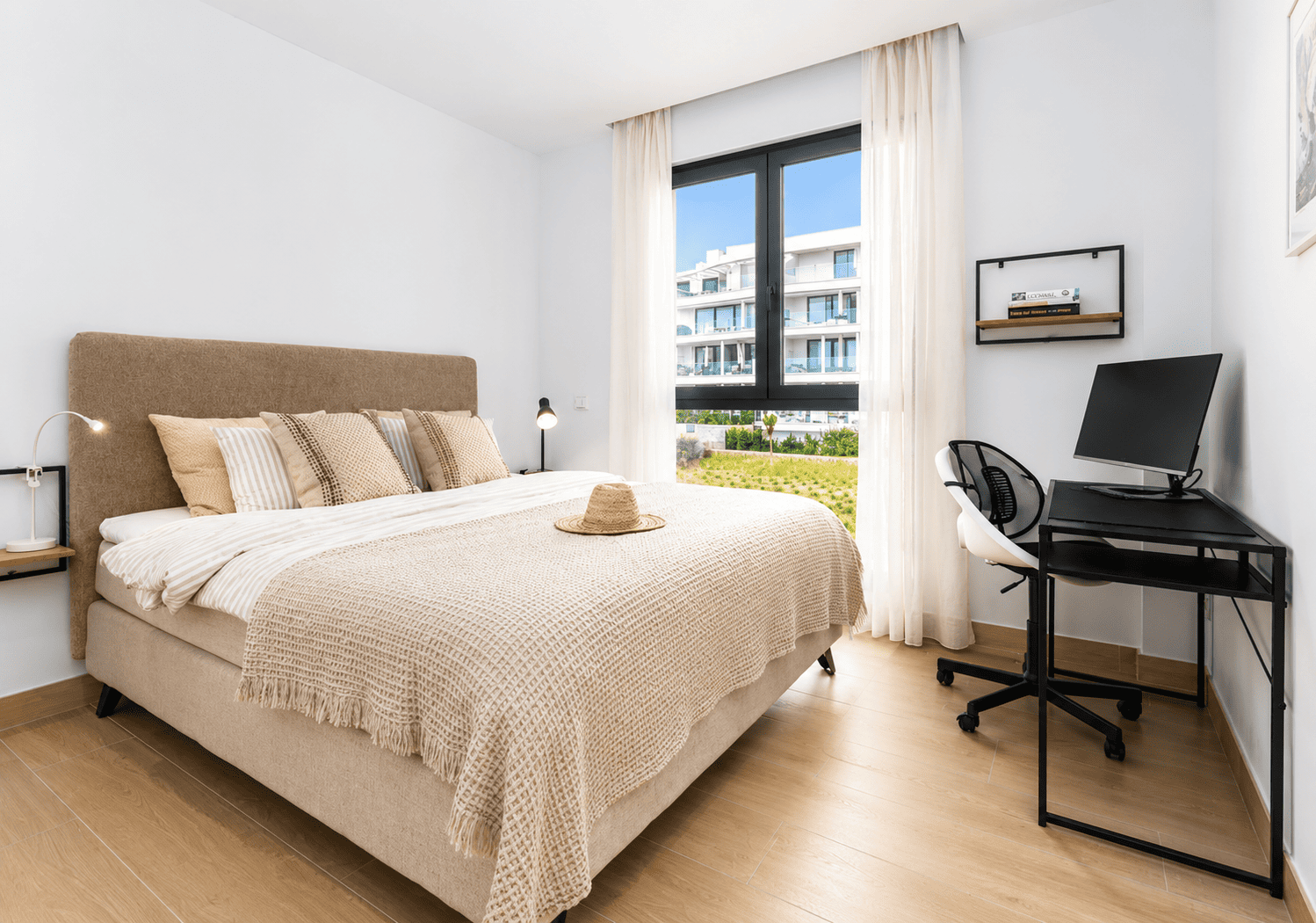 Bedroom with desk workspace and garden views